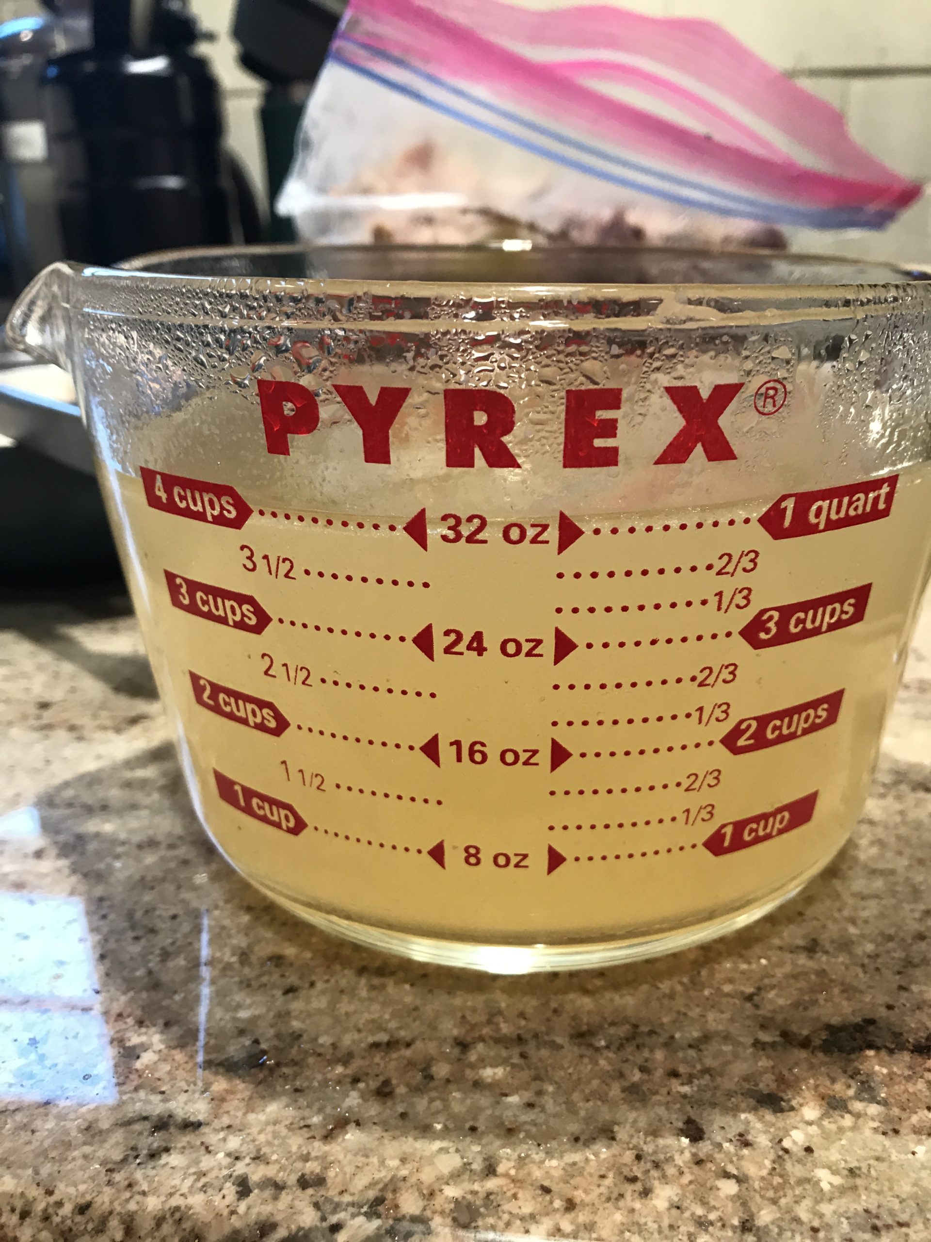 Measuring cup of homemade chicken broth