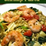 Shrimp with fresh vegetables and pesto served over pasta