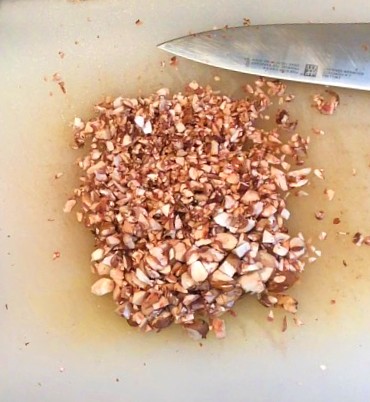 Chopped mushrooms on a cutting board for the beef and mushroom burger.