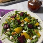 A salad with beets, oranges and goat cheese.