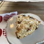 A plate with a dried cherry and almond scone