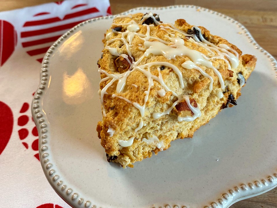 A plate with a dried cherry and almond scone