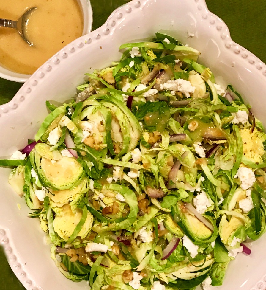 Shaved Brussel Sprout Salad in a white serving bowl.