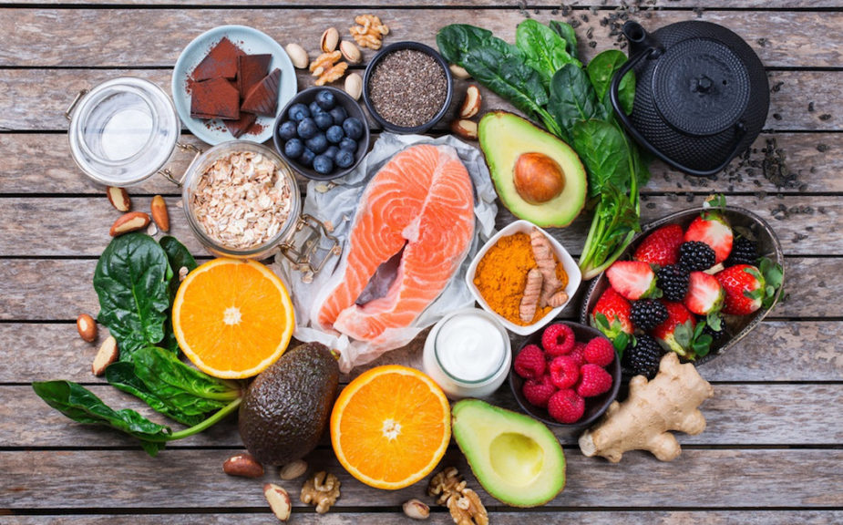 A variety of foods that are good for stress relief on a wooden board