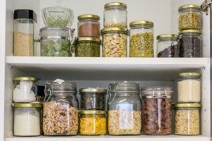 Glass jars filled with pantry staples on shelves