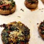 A sheetpan of cooked stuffed mushrooms