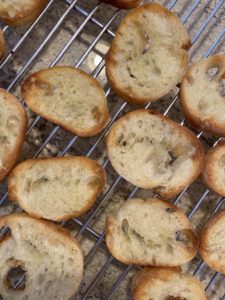 Toasted Crostini cooling on a wire rack