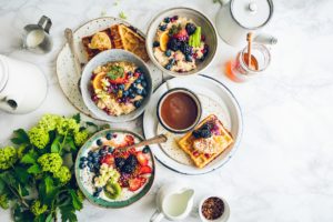 A table set with berries and oatmeal, whole grains