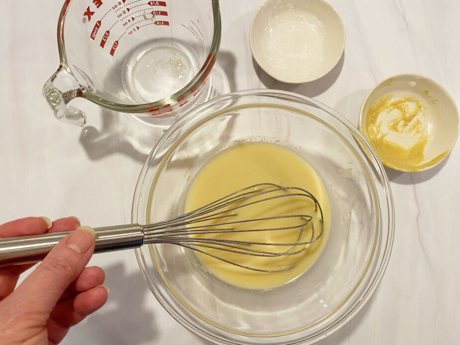 Whisking dijon mustard, corn starch and white wine together