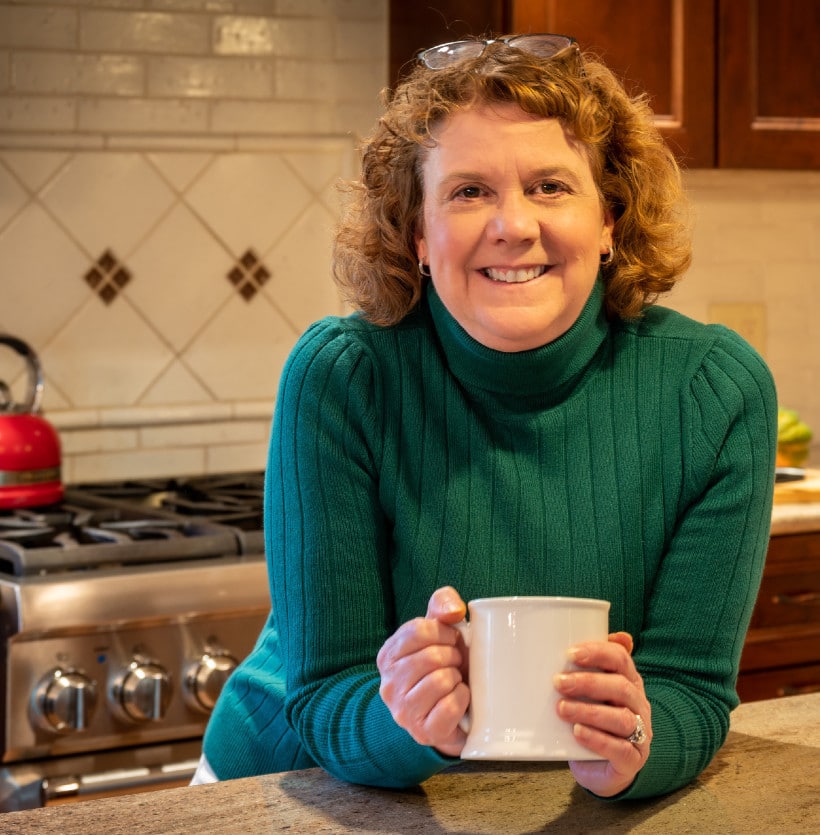 Laura Ali in her kitchen enjoying a cup of coffee