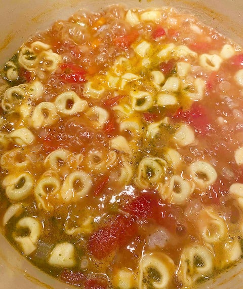 Pasta cooking in the Italian sausage and white bean soup