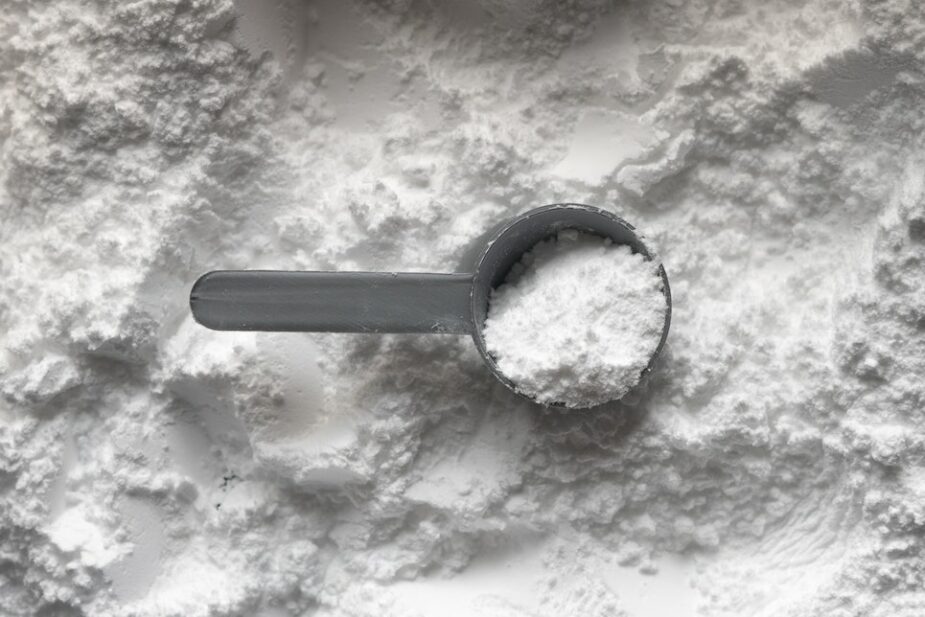 White collagen powder with a black scoop