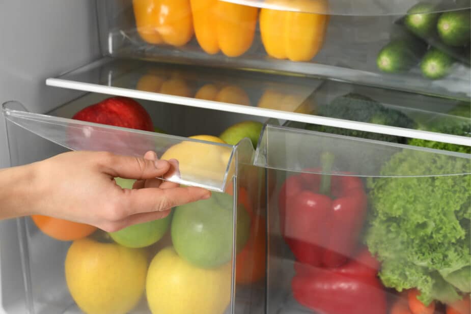 Refrigerator bins full of fruits and vegetables