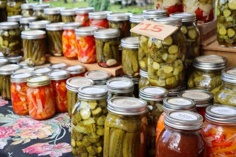 A table full of mason jars filled with homemade pickled vegetables is a great way to add some good mood food to your meals