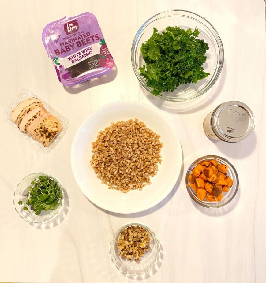 Ingredients used to make an Ancient Grains Bowl on a white marble counter