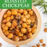 A small wooden bowl filled with rosemary roasted chickpeas