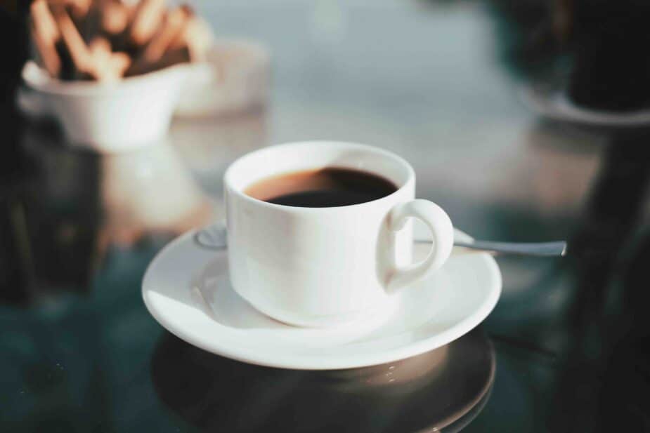 A cup of coffee on a glass top table