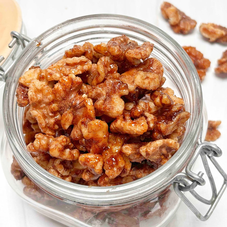 A glass jar filled with spiced walnuts