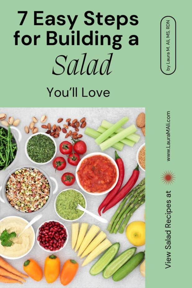 A group of salad ingredients on a slate counter with the title "7 Easy Steps for Building a Salad You'll Love" above the photo.