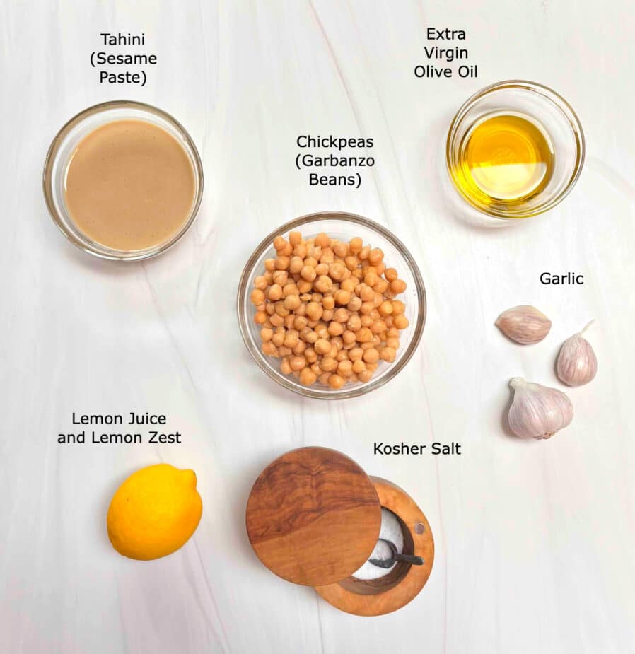 Ingredients used to make hummus on a white counter