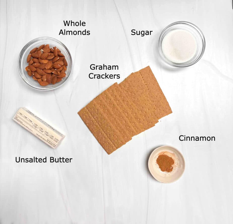 Ingredients used to make the almond graham cracker crust including graham crackers, almonds, sugar, butter and cinnamon