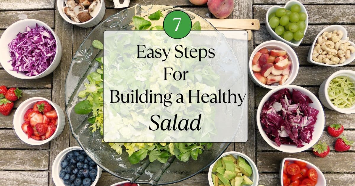 A bowl of lettuce surrounded by fresh fruits and vegetables. The Title "7 Easy Steps for Building a Healthy Salad is in a box overtop.