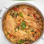 A dark green banner on top says "Chicken Orzo with Sundried Tomatoes. Below that is a picutre of a saute pan filled with cooked orzo, chicken breasts, sundried tomatoes, mushrooms and spinach. It is sitting on a marble counter. In a green bubble at the bottom it says "MIND Diet Friendly"