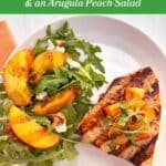 Grilled swordfish steak topped with grilled peaches and an arugula salad on the side. In a green bar along the top, the title is listed: "Grilled Swordfish with Grilled Peaches & an Arugula Peach Salad"