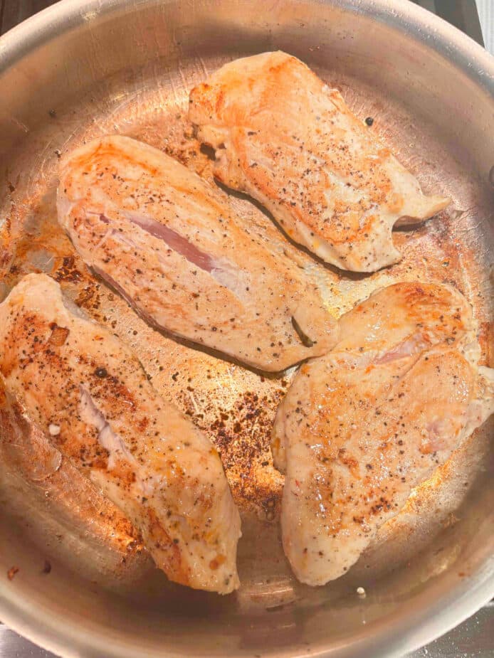 Seared and Browned Chicken Breasts in a metal sautepan