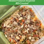 A square glass casserole pan filled with brown and wild rice salmon casserole topped with crunchy almonds. Mediterranean Inspired and RD Created is called out below the title above the picture.