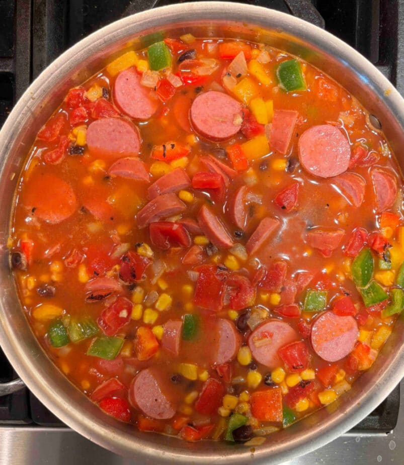 Rice and sausage ready to simmer Sausage, vegetables and rice simmering on the stove