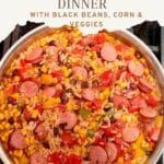 Rice, sausage and beans with vegetables in a saute pan on the stove.