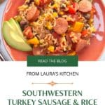 An orange, southwestern style bowl filled with brown rice and hearty vegetables, beans and smoked sausage.