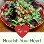 A red plate filled with a bean salad. "Nourish Your Heart with Beans" is below the picture