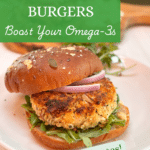 Salmon cake on a hearty whole grain bun topped with red onions.