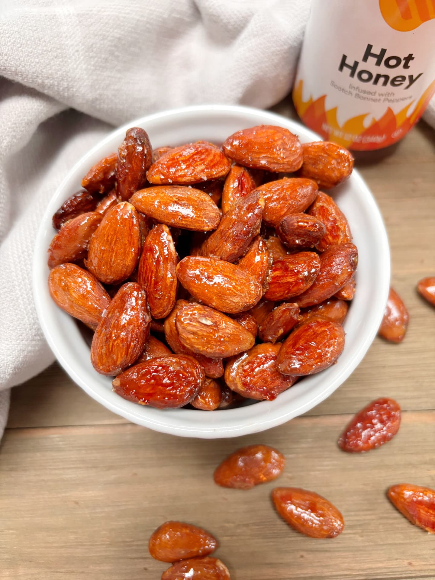 A white bowl filled with hot honey almonds