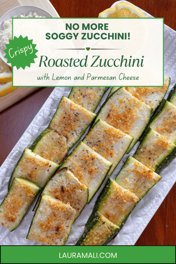 Roasted Zucchinipng A platter filled with crispy zucchini strips with a bowl of parmesan cheese and lemon slices in the background