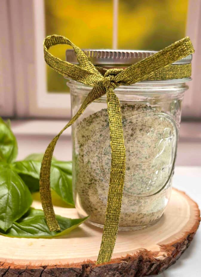 Basil Salt gift Basil salt in a small mason jar with a decorative ribbon around the top.