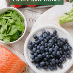 A wooden table filled with brain healthy foods like berries and leafy greens